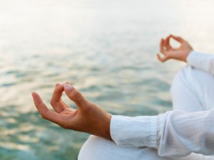 Woman practicing yoga at sunrise